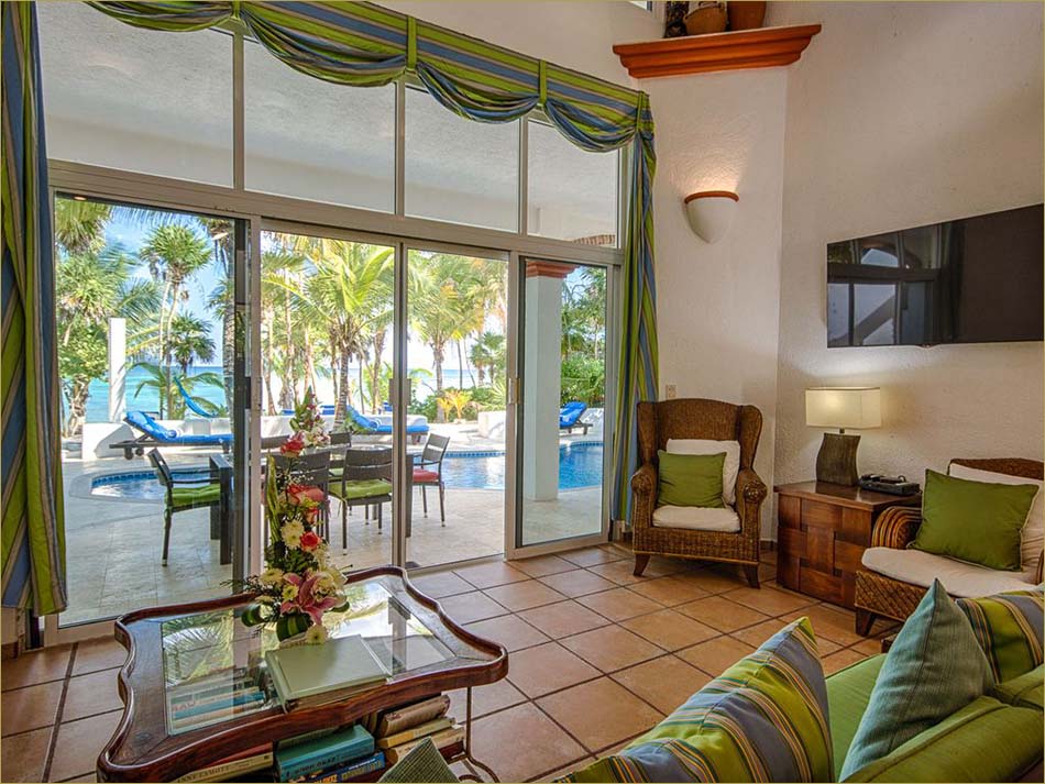 Spacious open living room with direct access to the pool and beachfront