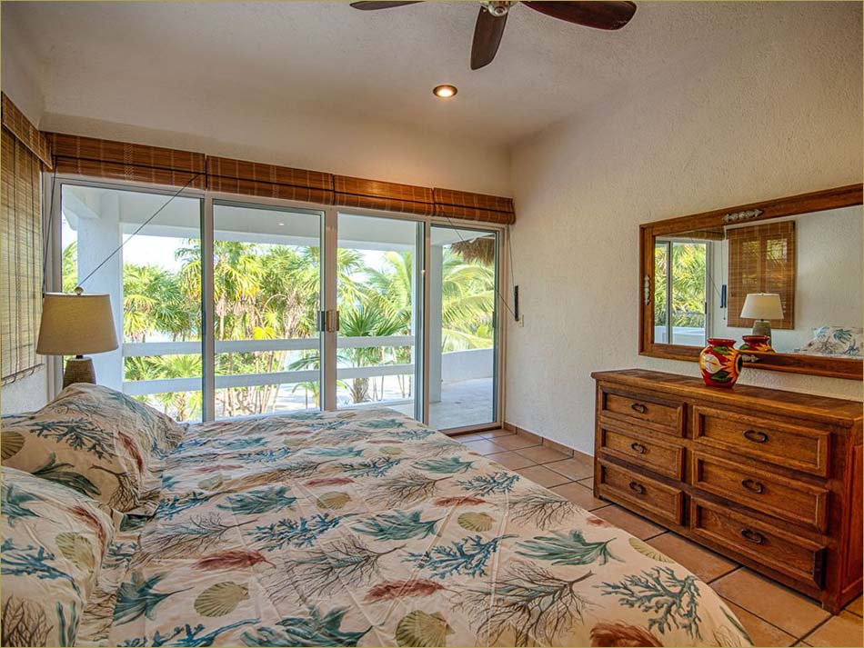 Upstairs master bedroom with king bed, upper deck access and en-suite bathroom.