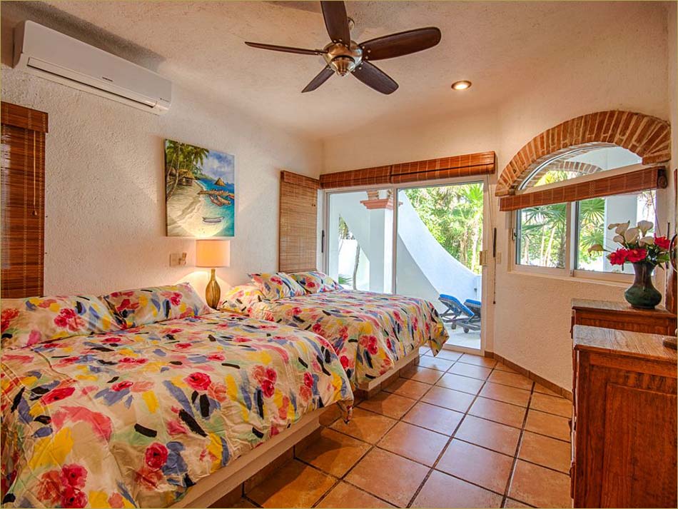 Lower level third bedroom encludes a private bathroom and pool side patio overlooking beach.