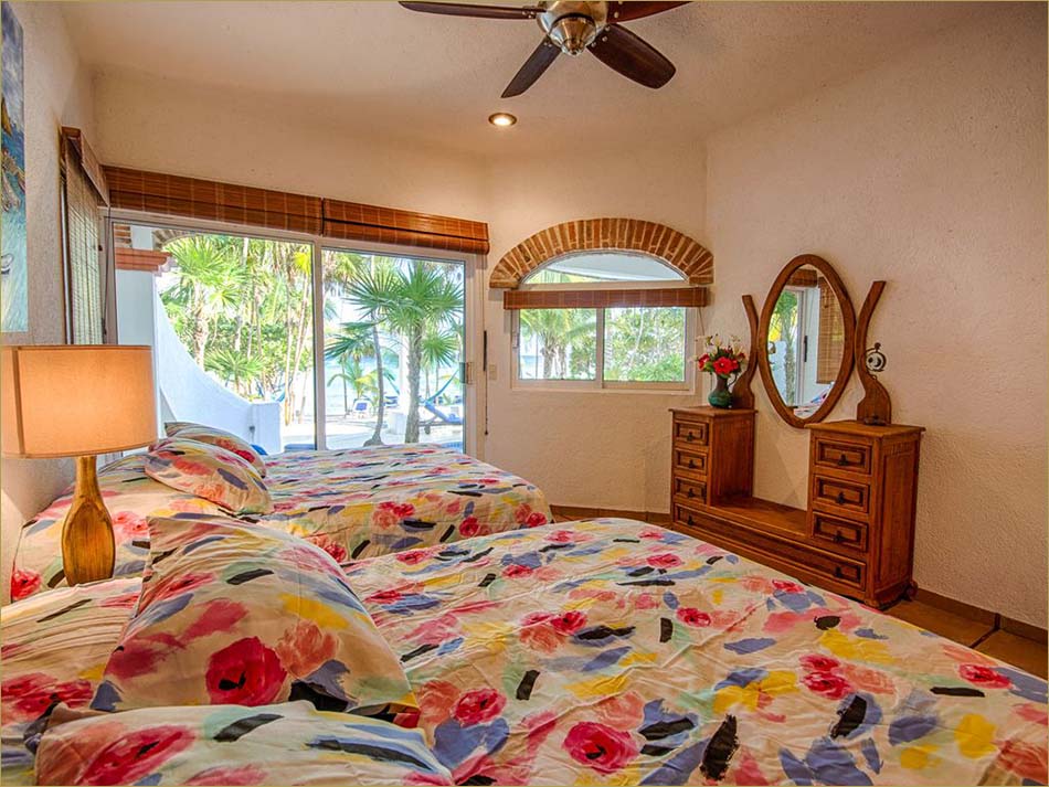 Lower level third bedroom encludes a private bathroom and pool side patio overlooking beach.