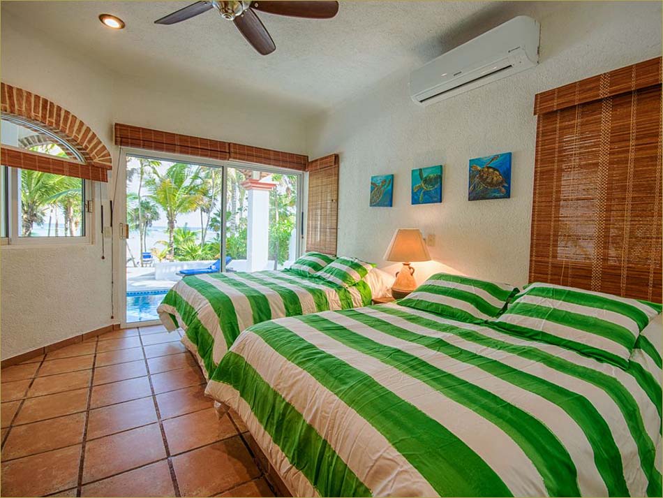 Lower level third bedroom encludes a private bathroom and pool side patio overlooking beach.