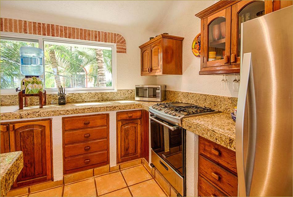 Gourmet kitchen with profession appliances, granite countertops and stone tile floors.