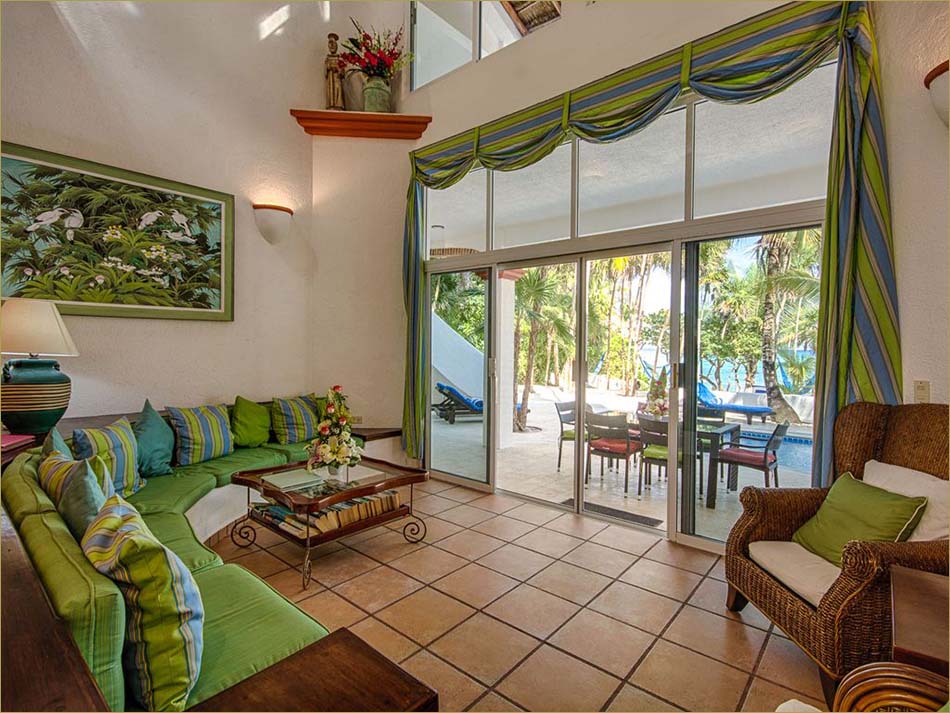 Spacious open living room with direct access to the pool and beachfront