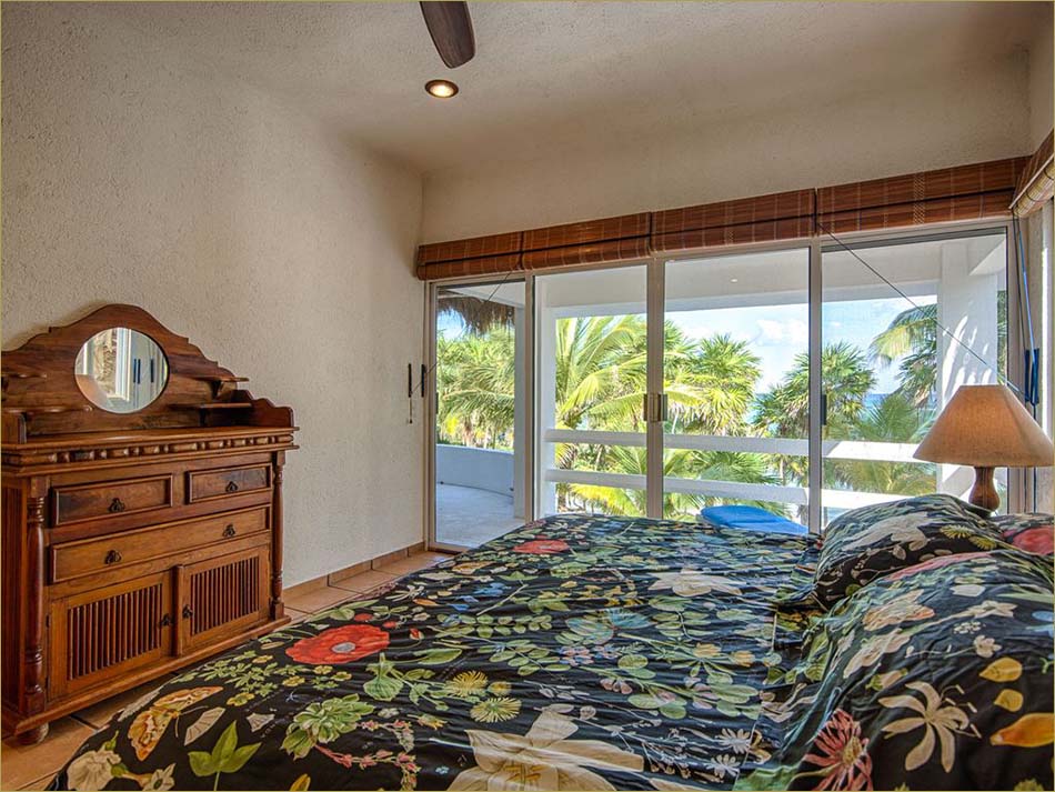 Master bedroom upstairs features a king sized bed, open balcony and private bathroom.