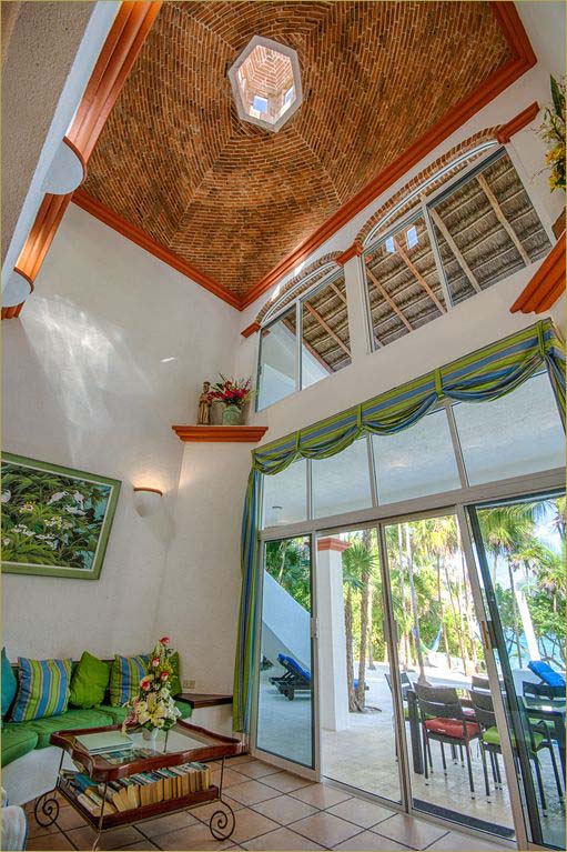 Spacious open living room with direct access to the pool and beachfront